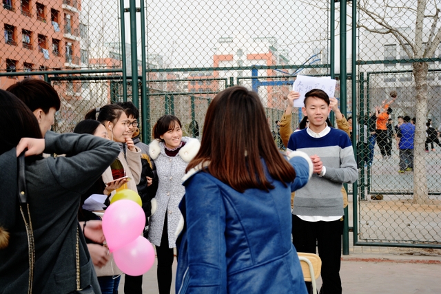 he for she”户外活动中,男生和女生一起猜字谜 he for she”户外活动中,男生和女生一起猜字谜